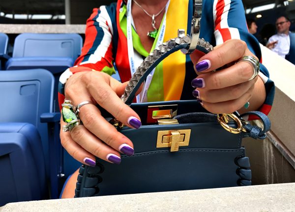 NEW YORK, NY - SEPTEMBER 09: A tennis fan places her designer bag on a hanger in box seats at Arthur Ashe stadium during Day Twelve of the 2016 US Open at the USTA Billie Jean King National Tennis Center on September 9, 2016 in Queens. (Landon Nordeman for ESPN)