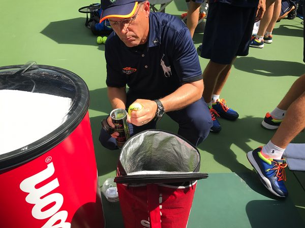 NEW YORK, NY - SEPTEMBER 09: A ball handler tests the tennis balls during the Mixed doubles final Laura Siegemund (GER) Mate Pavic (CRO) def. Coco Vandeweghe (USA) [7] Rajeev Ram (USA) [7] at Arthur Ashe stadium on Day Twelve of the 2016 US Open at the USTA Billie Jean King National Tennis Center on September 8, 2016 in Queens. (Landon Nordeman for ESPN)