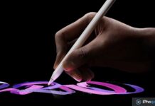 Main tenant un Apple Pencil en train de dessiner