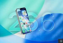 iPhone affichant l’écran d’accueil avec le visuel iOS 26.6