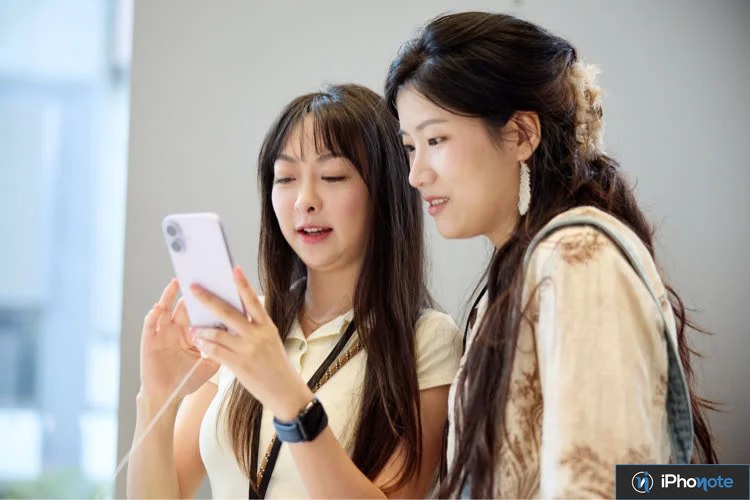 Deux femmes regardent un smartphone dans un magasin
