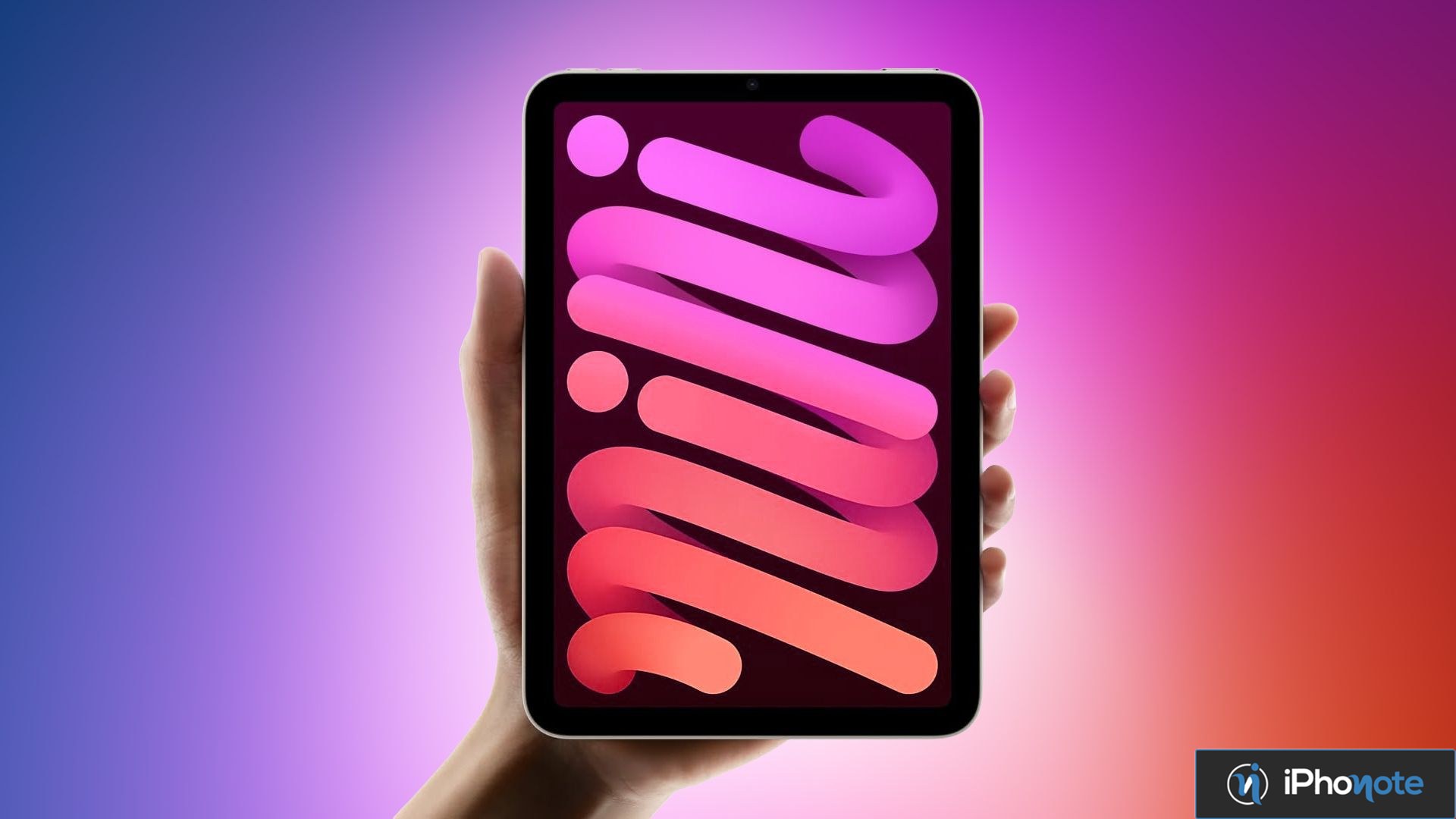 Une tablette compacte tenue en main affiche un fond d’écran coloré.